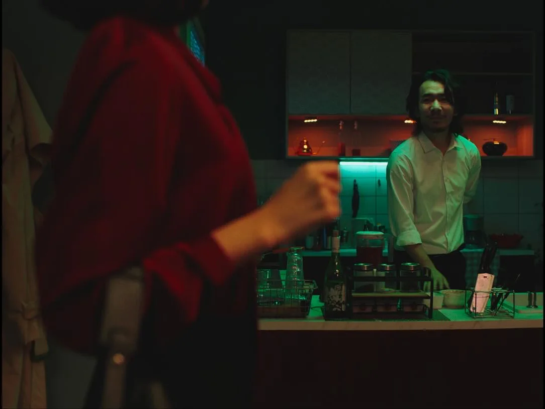 Two figures divided across the kitchen