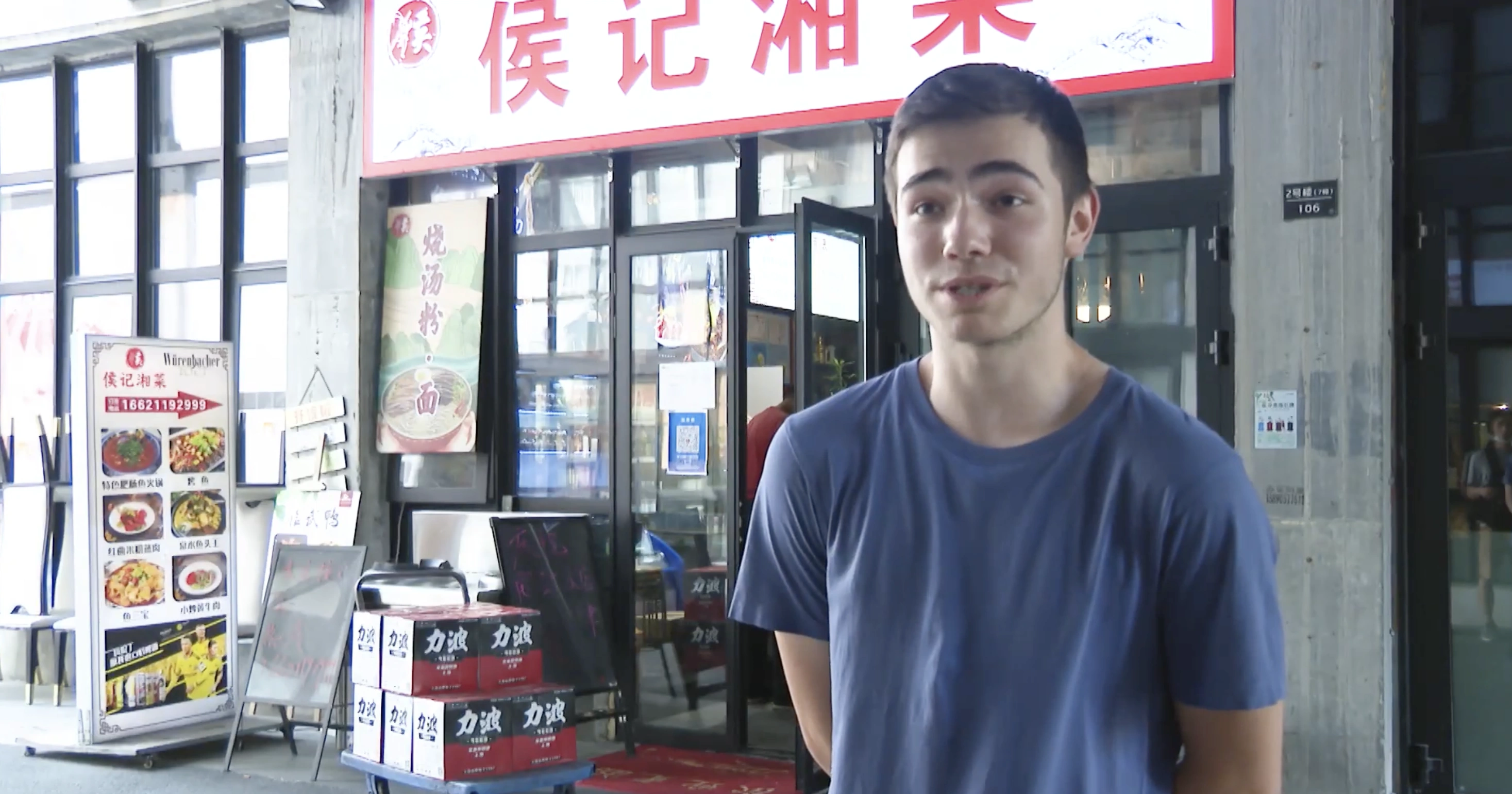 The intern stands outside a restaurant in Shanghai